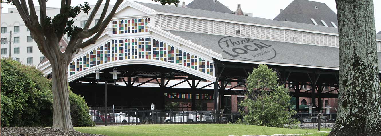 photo of the train station in downtown Montgomery Alabama.  stained glass covers the rooftop of the structure housing the station.