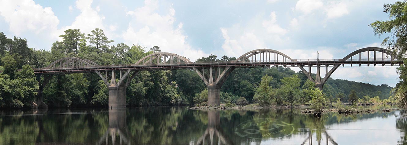 photo of a large concrete bridge over water 