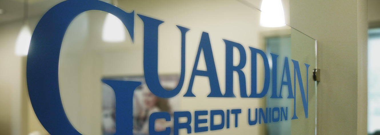 Image of blue Guardian Credit Union logo on glass window