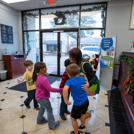 Children hugging Maplesville Kindergarten Christmas Event for Guardian CU annual giveback