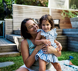 Smiling mother and daughter enjoying time in the backyard, supported by Guardian Credit Union’s personal loans