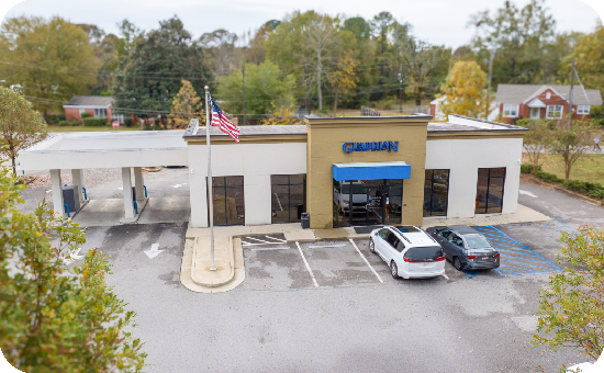 Exterior view of Guardian Credit Union’s Tallassee branch building, with visible parking lot and landscaped surroundings