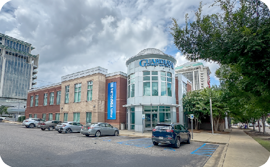 Exterior view of Guardian Credit Union’s 418 Madison Ave branch building, with visible parking lot and landscaped surroundings
