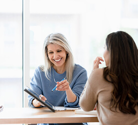 Guardian Credit Union team member meeting with a member to discuss financial options in a bright, welcoming space