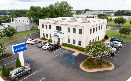 Exterior view of Guardian Credit Union’s Federal branch building, at Congressman W L Dickinson Drive, with visible parking lot and landscaped surroundings