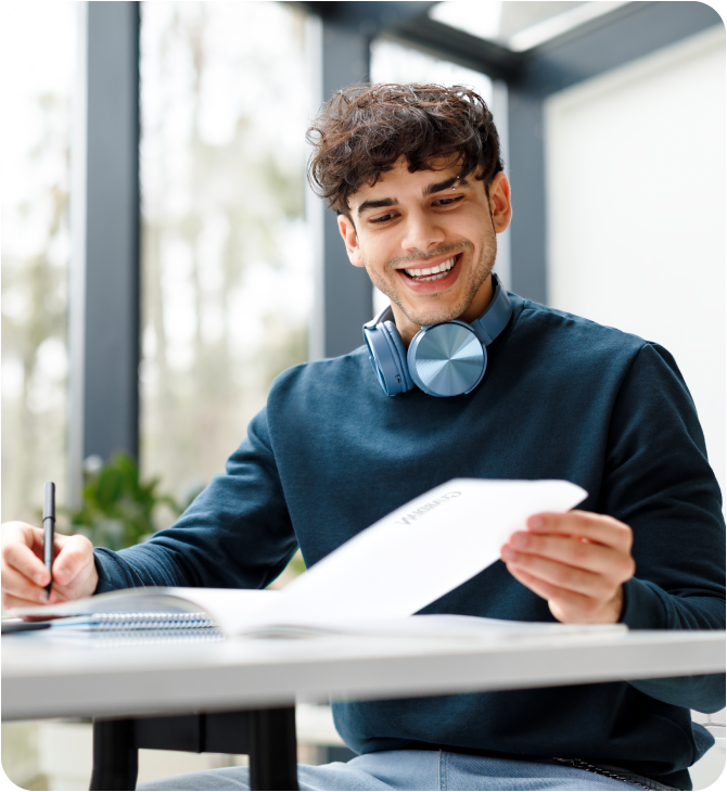 Young man happily reviewing documents, planning his financial future with Guardian Financial Planning.