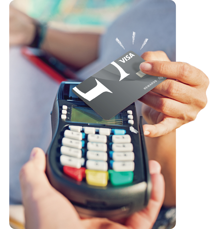 Guardian Credit Union Member tapping his Visa Rewards Credit Card at a machine.