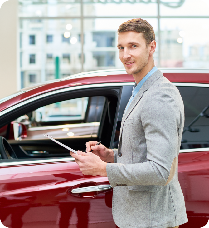 Guardian Insurance agents beside a red car, ensuring your tailored coverage keeps you protected on the road.