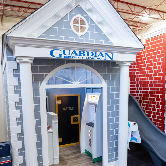 Guardian Credit Union team at YMCA Tiny Towns, celebrating the opening of a kid-sized Guardian branch to inspire financial learning