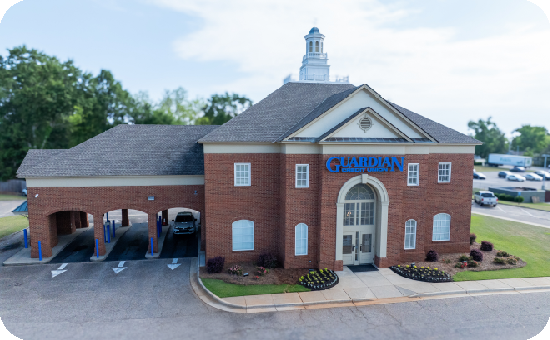 Exterior view of Guardian Credit Union’s Troy branch building, with visible parking lot and landscaped surroundings