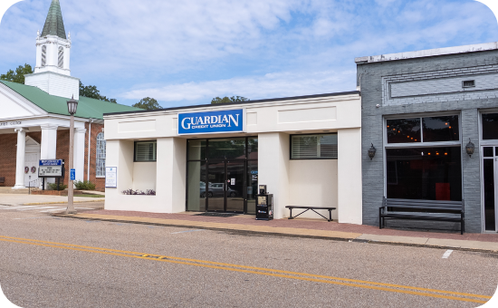 Exterior of Guardian CU’s Maplesville branch with drive-thru and landscaped surroundings.