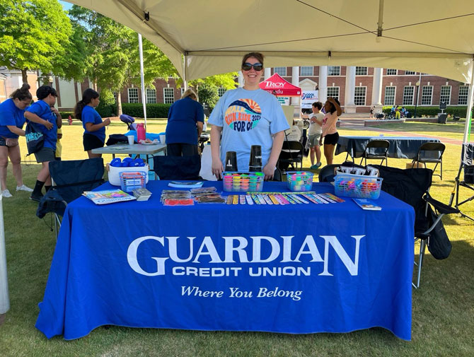 Guardian Credit Union team member at O's Cool Bike event, showcasing setup for youth safety outreach