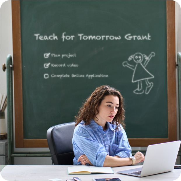 Teacher applying online for Teach for Tomorrow Grant with checklist on chalkboard behind her.