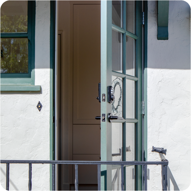 Busted front door with broken glass left wide open after a burglary while the residents were away.